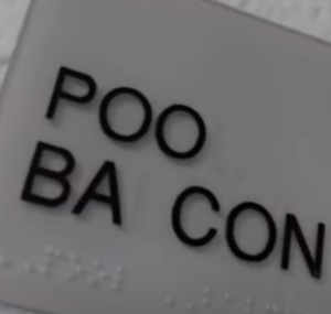 Vandalized sign reading "POO BACON".png